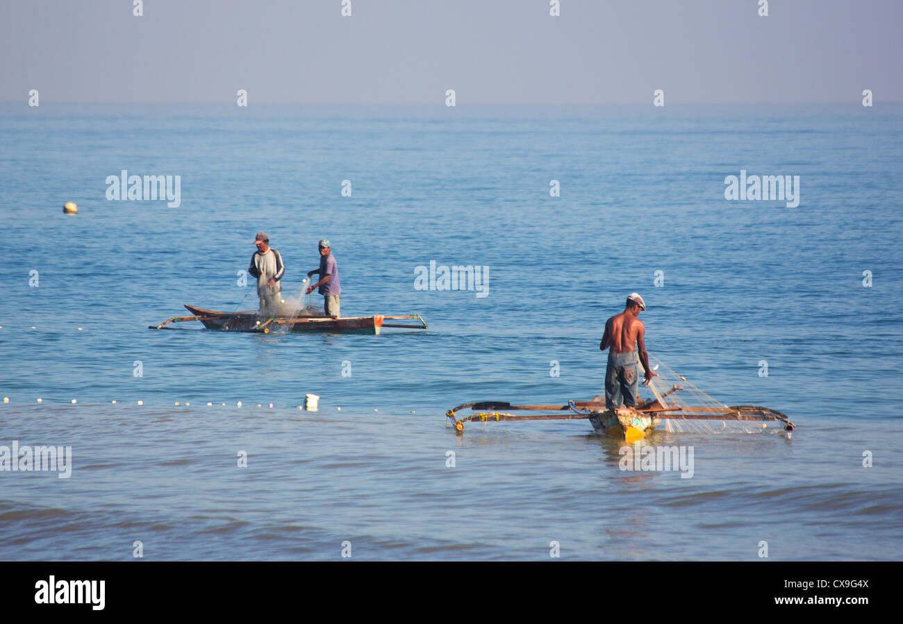 Men fishing from traditional fishing boats off the coast of Dili, East Timor Stock Photo