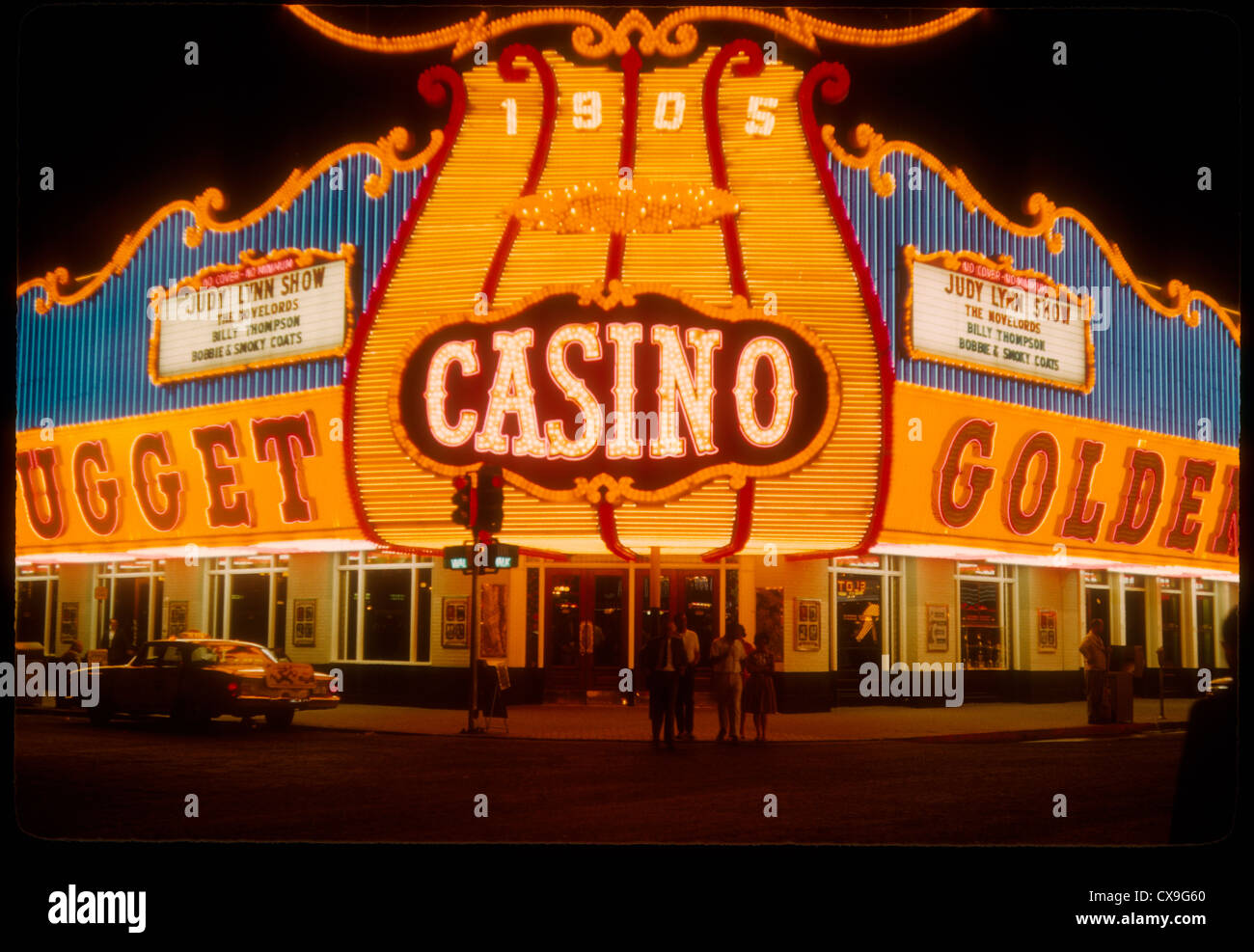 Las Vegas color 1962 strip neon sign gambling casino night 1905 Golden Nugget exterior Stock Photo