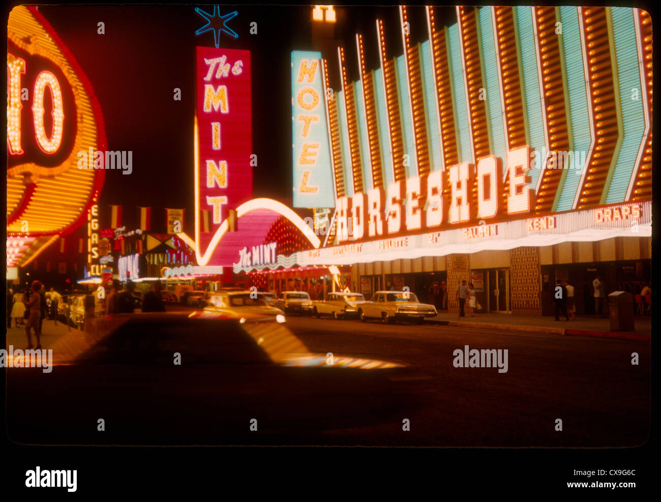 Las Vegas color 1962 strip neon sign gambling casino night the mint horseshoe hotel sin city 1960s Stock Photo