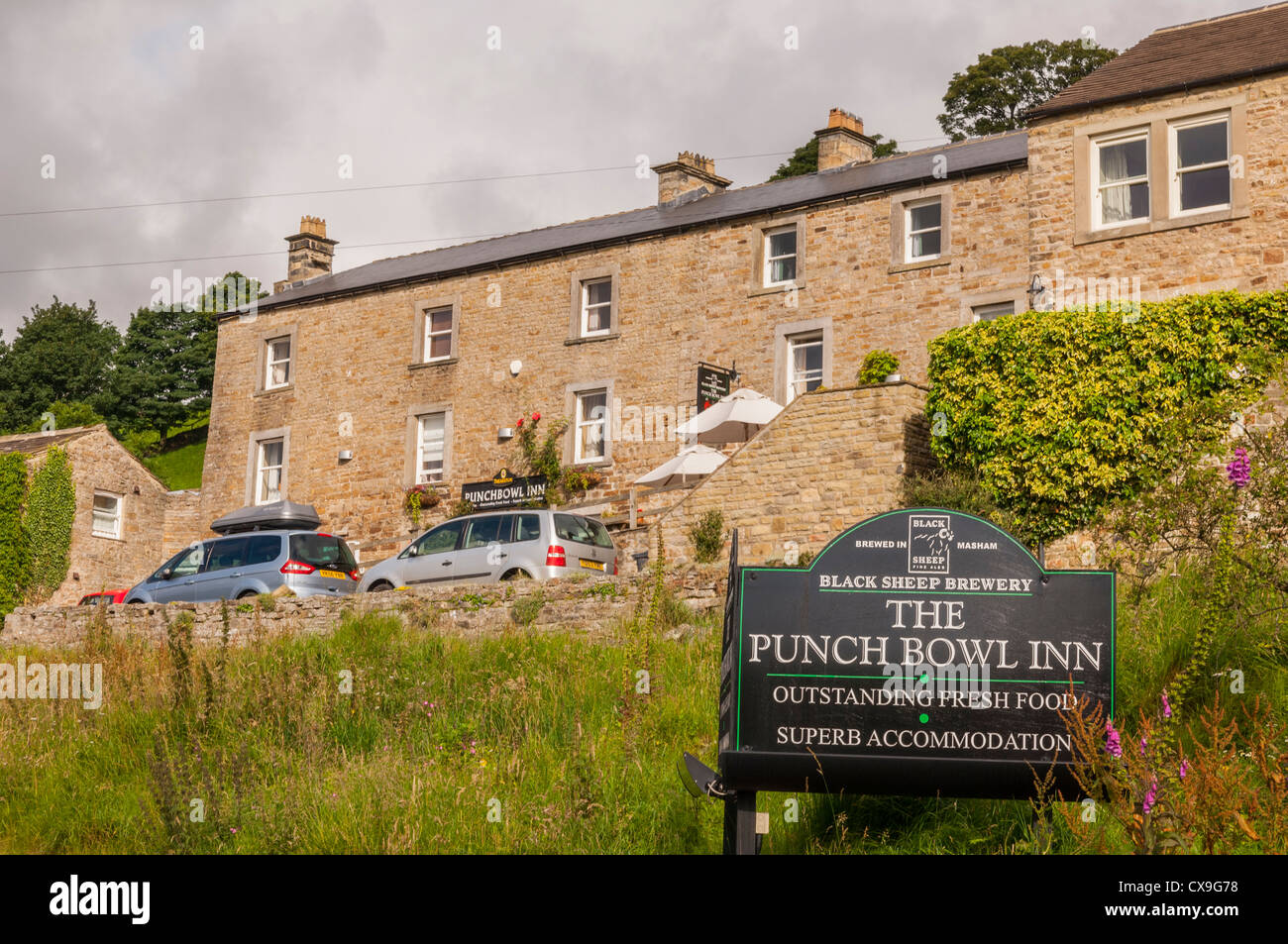 The pub sign of the Punch Bowl Inn at Low Row in Swaledale , Yorkshire Dales , England , Britain , Uk Stock Photo