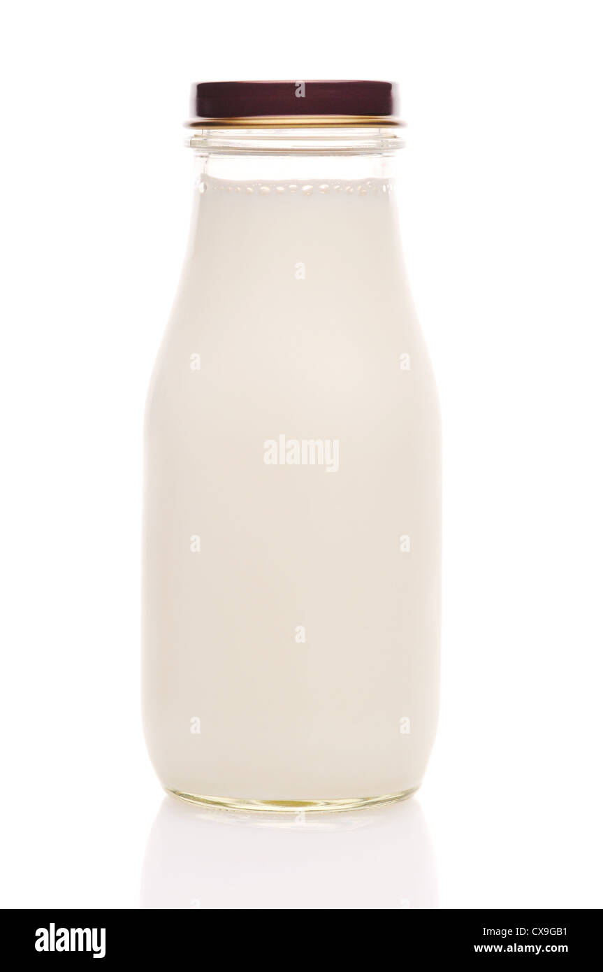 Old fashioned glass milk bottle isolated on white with reflection. Stock Photo