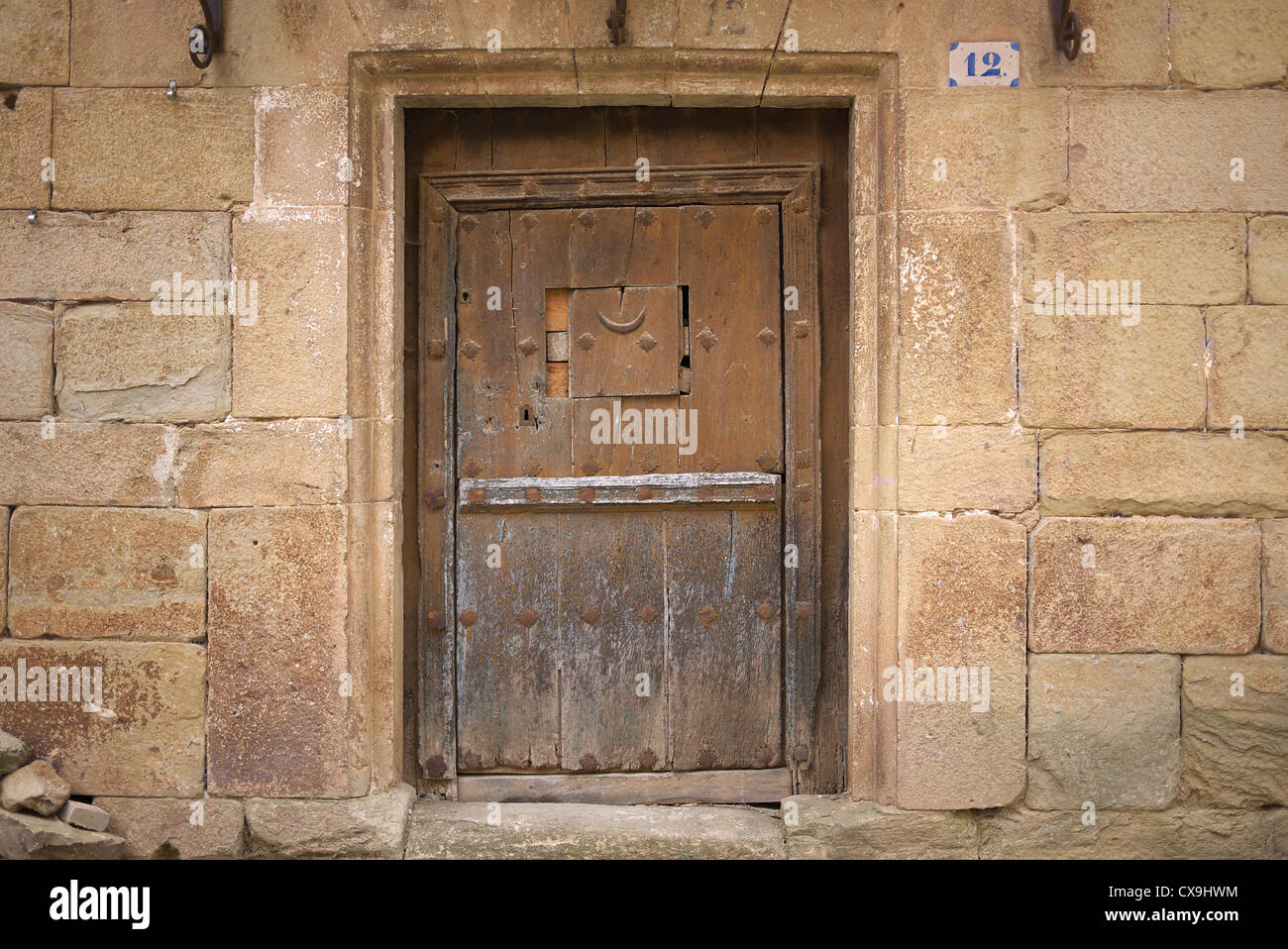 Old wooden door in Cirauqui, Spain. Stock Photo