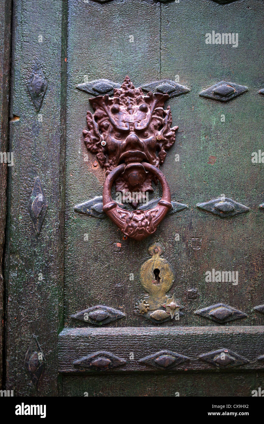 Decorative antique door knocker on a door in Spain. Stock Photo