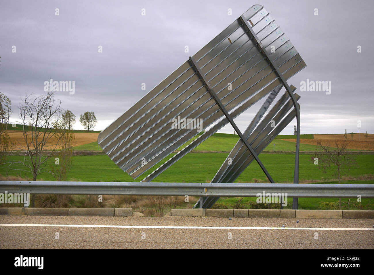 A road sign bent from high winds in Spain. Stock Photo