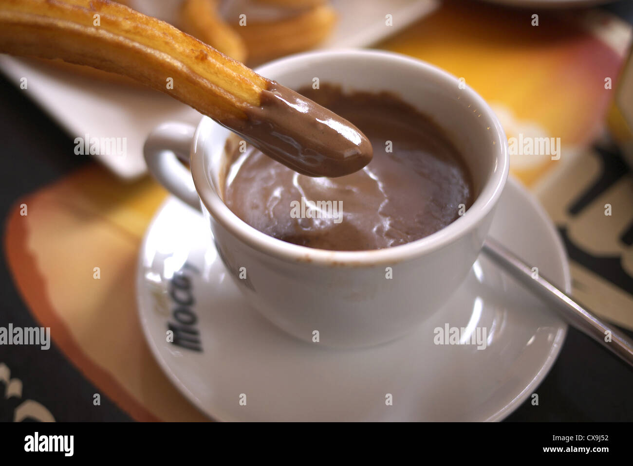 Churros dipped into a cup of hot chocolate in Astorga, Spain. Stock Photo