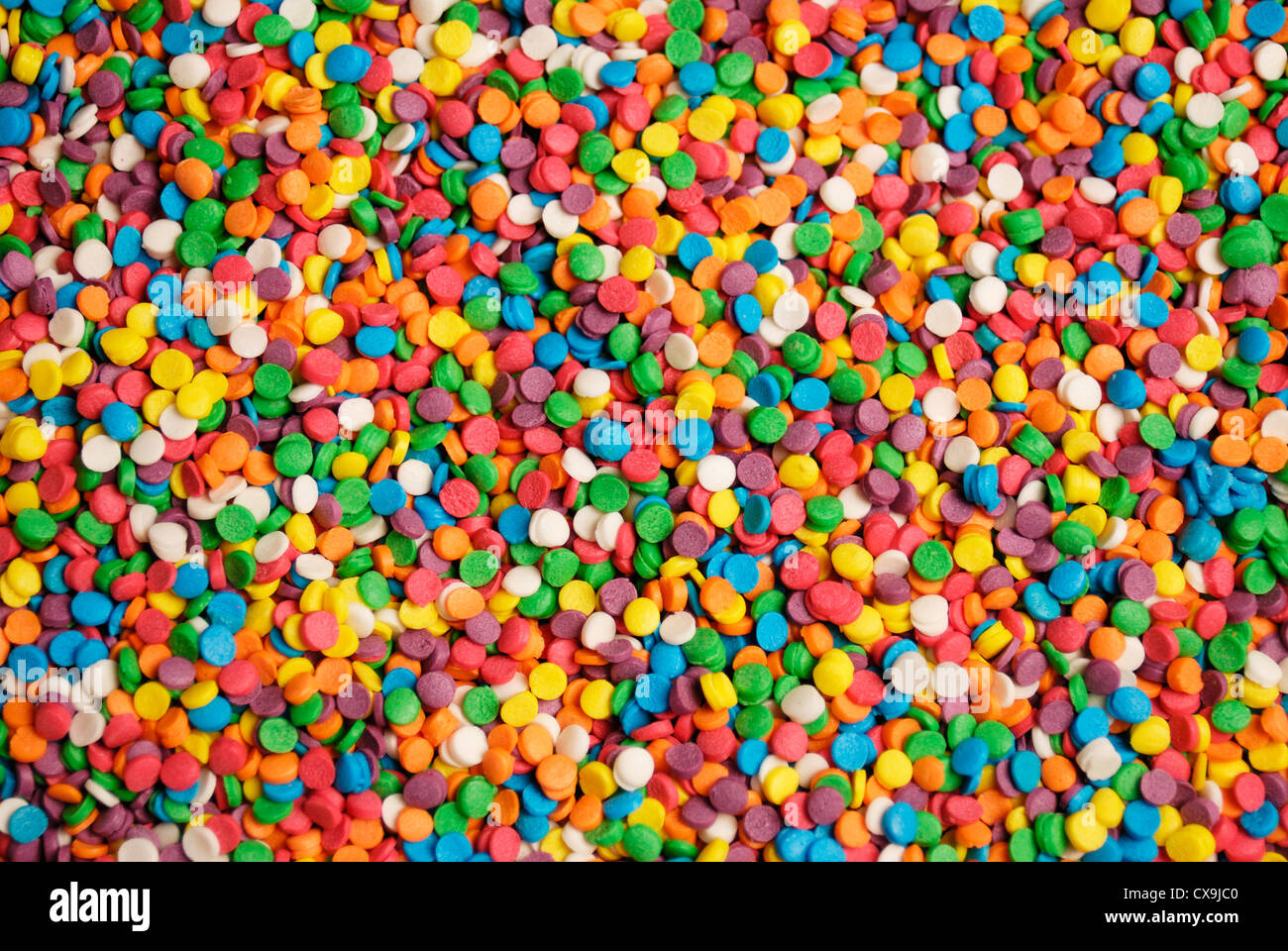 Rainbow sprinkle background closeup wallpaper Stock Photo Alamy