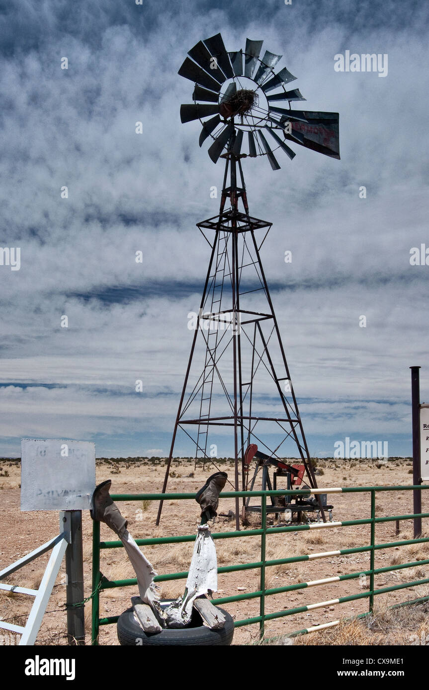 Old windmill and 'dead cowboy' at entrance to Bar W Ranch near Carrizozo, New Mexico, USA Stock Photo