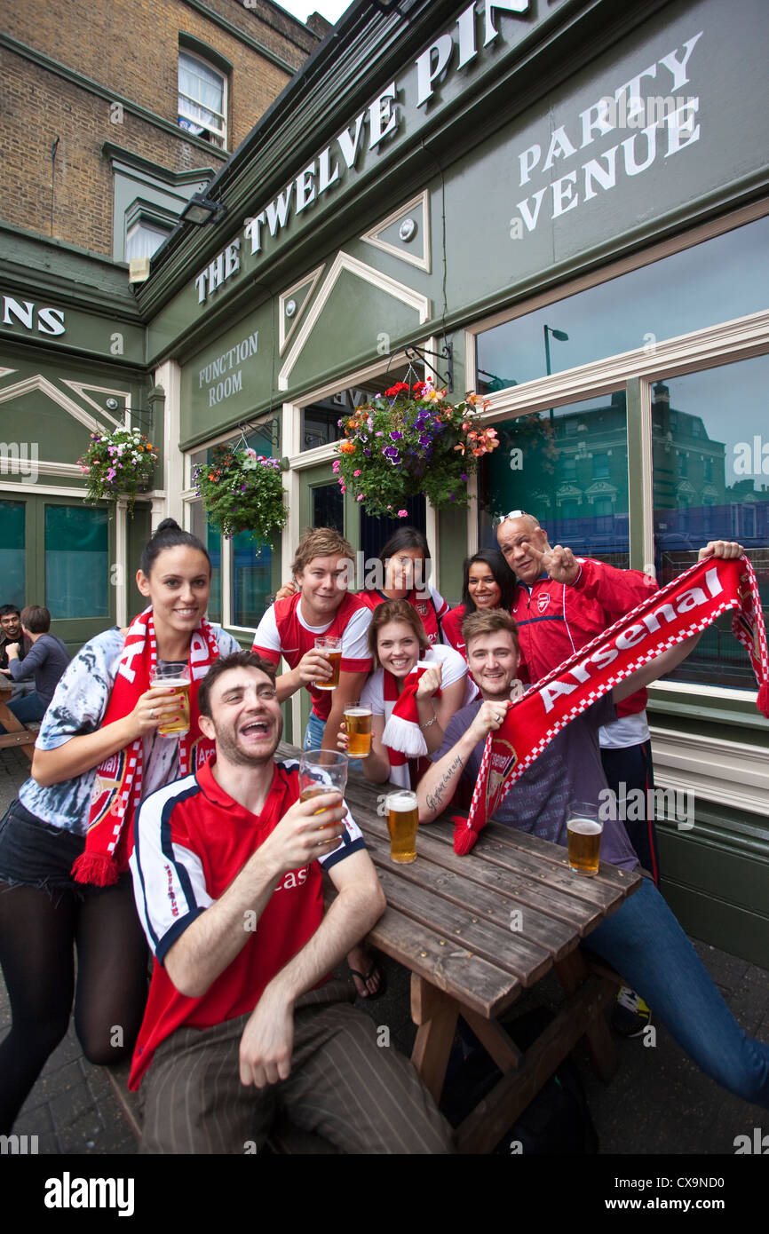 Arsenal football fans outside The Twelve Pins pub on match day in Finsbury Park, North London, England, UK Stock Photo