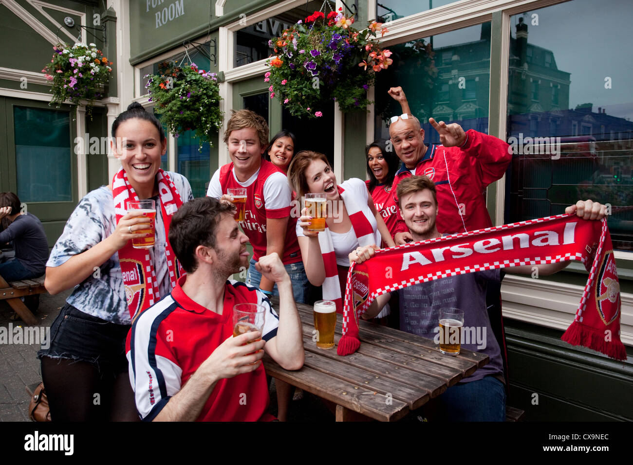 Arsenal football fans outside The Twelve Pins pub on match day in Finsbury Park, North London, England, UK Stock Photo