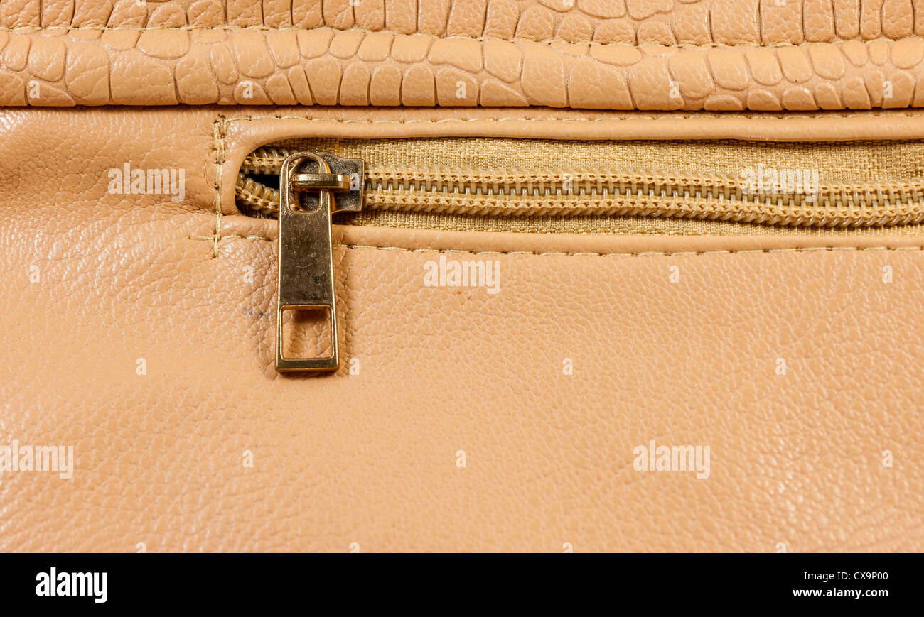 Closeup copper zipper of brown handbag leather Stock Photo