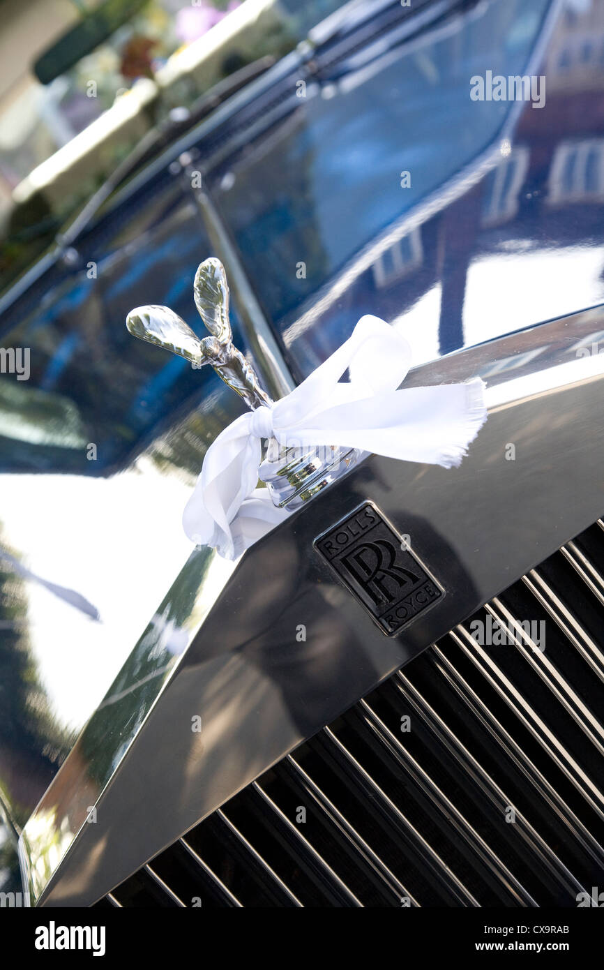 Rolls Royce Silver Shadow with white ribbon around the spirit of ecstasy ornament Stock Photo