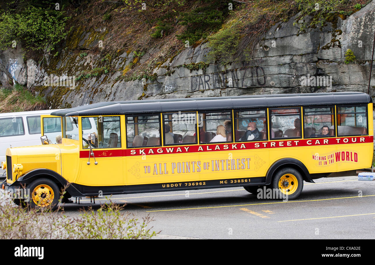Bright Yellow tour bus in Skakgway Alaska Stock Photo