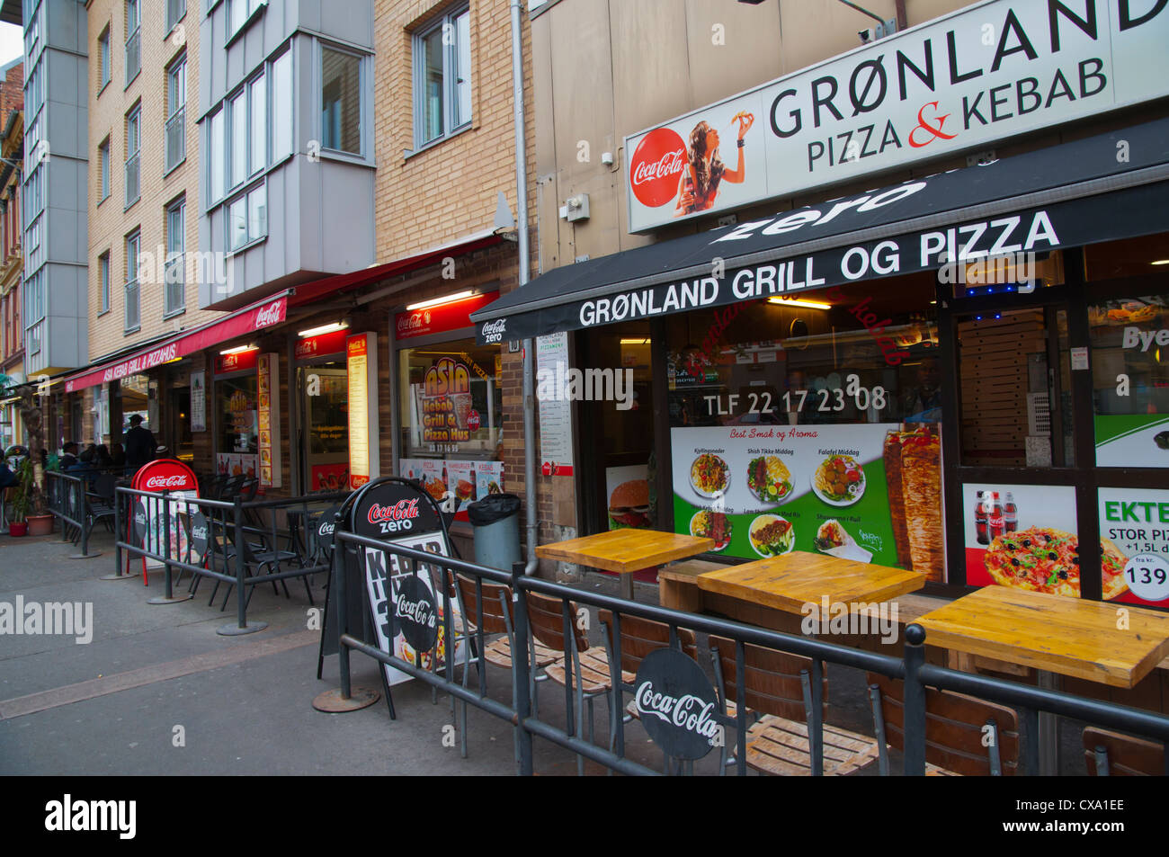 Fast food kebab and pizza restaurants and terraces along Gronland street Gronland district central Oslo Norway Europe Stock Photo