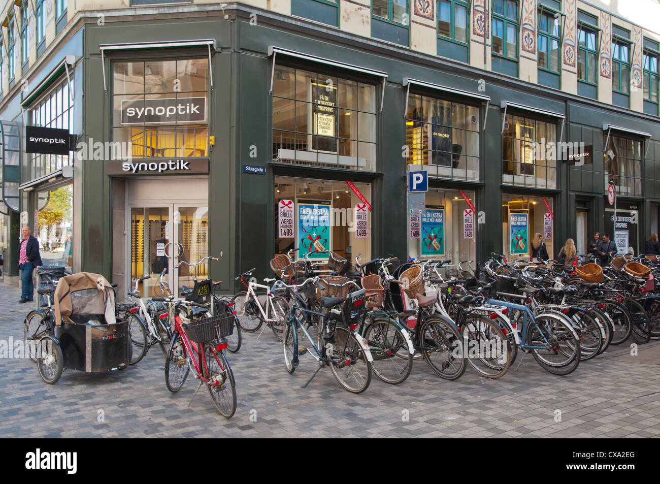 Parked bibycles along Kobmagergade street central Copenhagen Denmark Europe Stock Photo