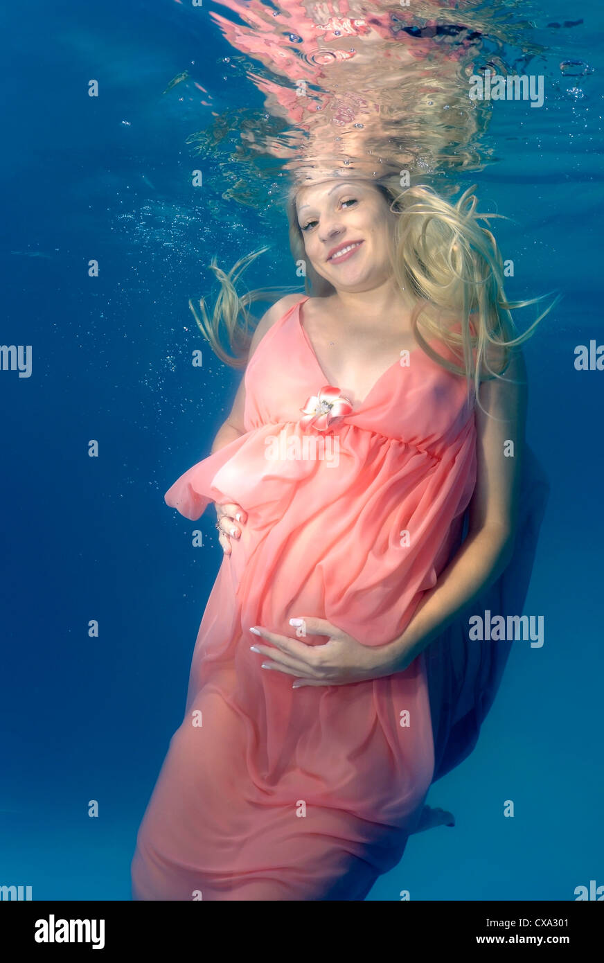 Pregnant woman swim swimming swims hires stock photography and images