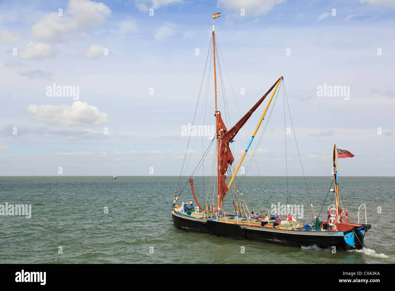 Traditional Thames sailing barge Greta leaving harbour to sail across estuary with day trippers on board on north Kent coast Whitstable England UK Stock Photo