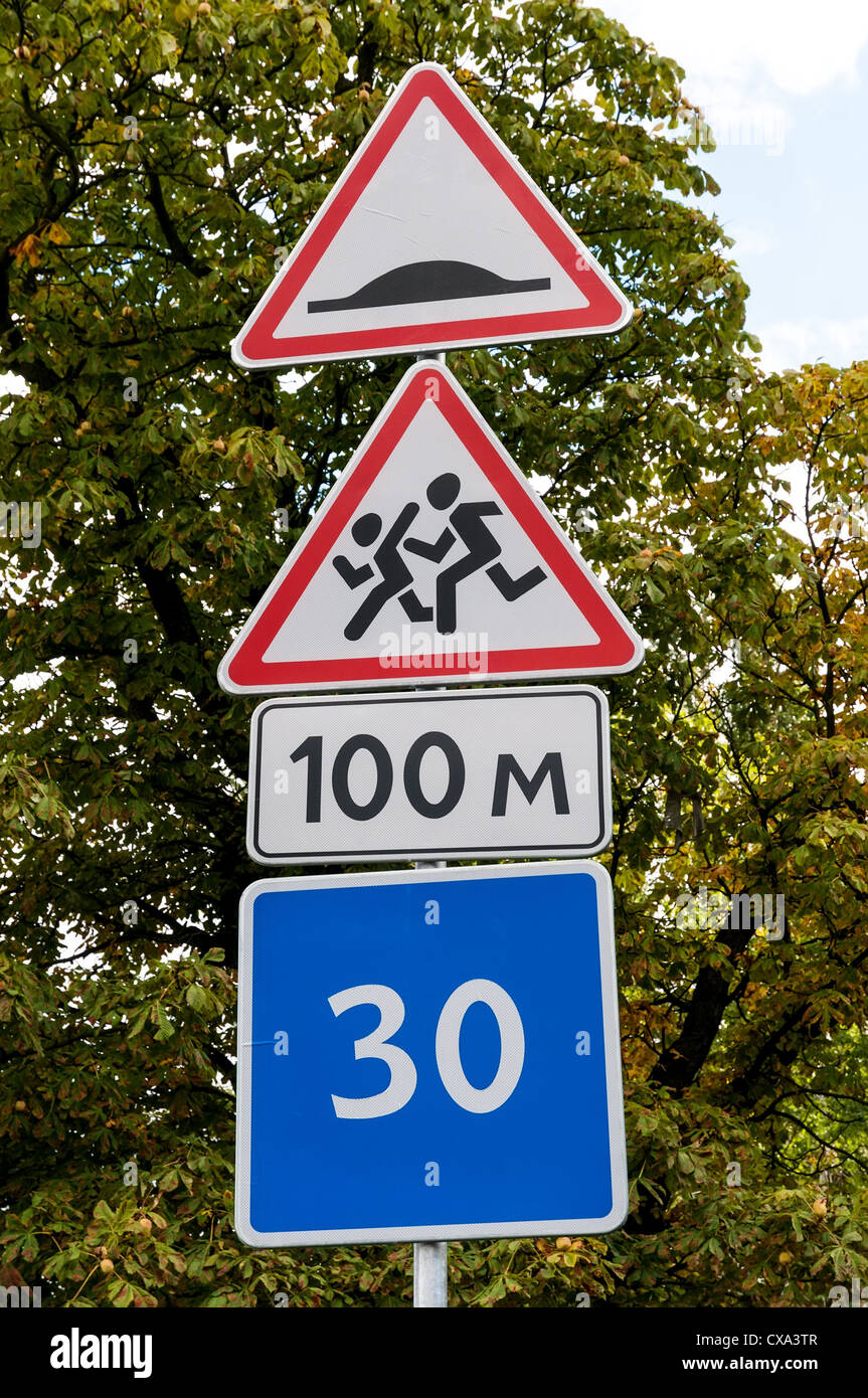 Road sign indicating children crossing and speed bump Stock Photo