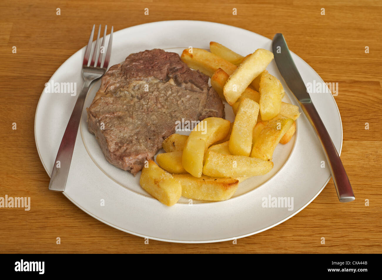 Steak and thickly-cut chips Stock Photo