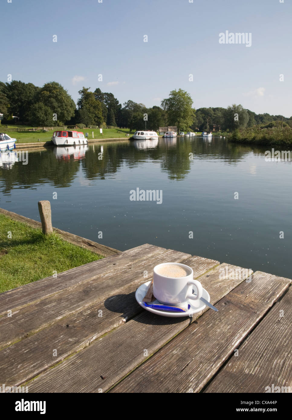 Coffee on table overlooking river in Norfolk, UK Stock Photo