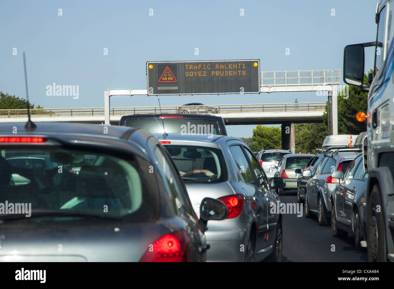Traffic jam on the French Autoroute in August with warning sign on