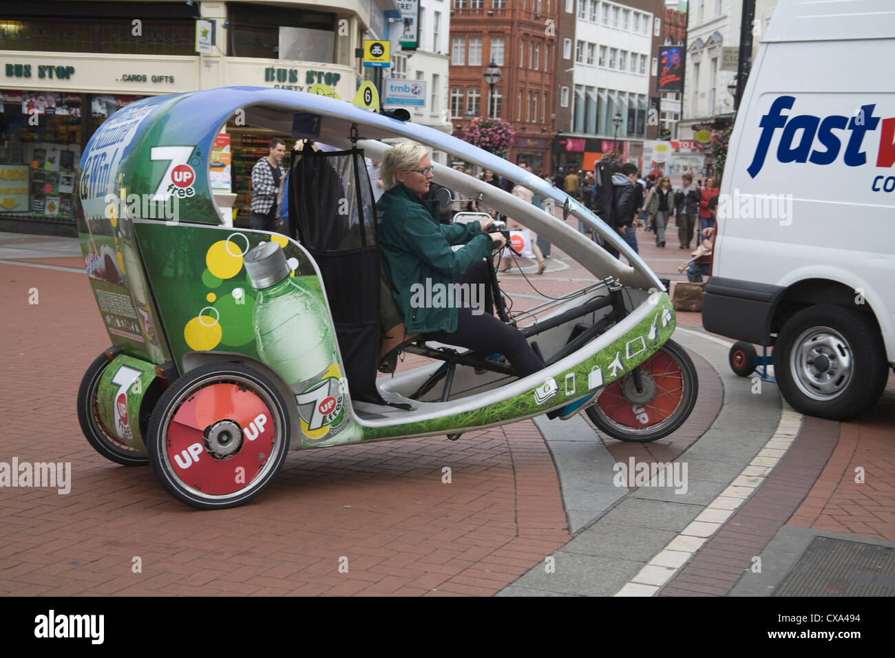 Dublin City Eire EU Young woman riding a cycle rickshaw in city centre Stock Photo