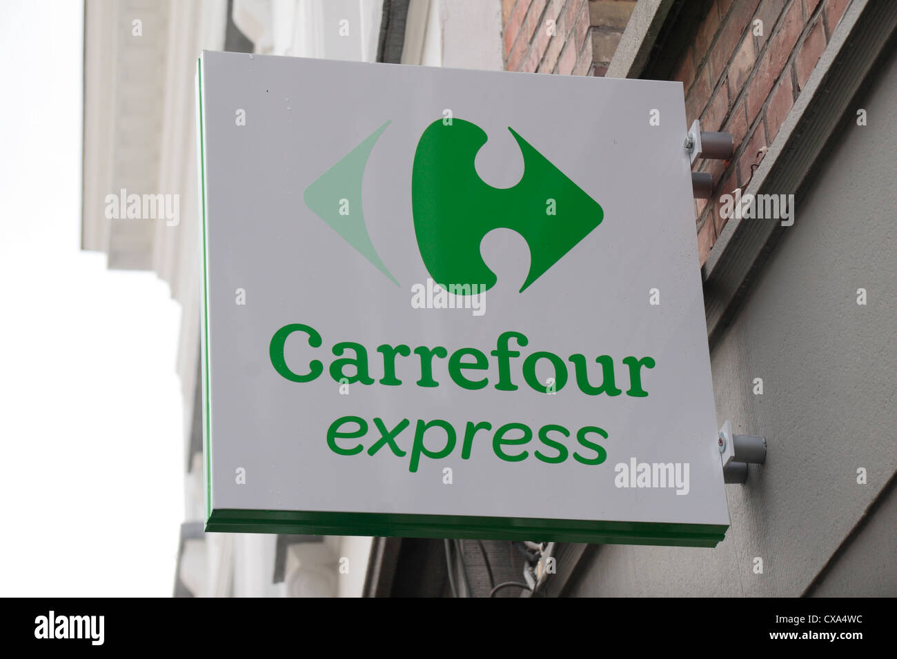 The Carrefour Express logo above a store in Bruges, Belgium. Stock Photo