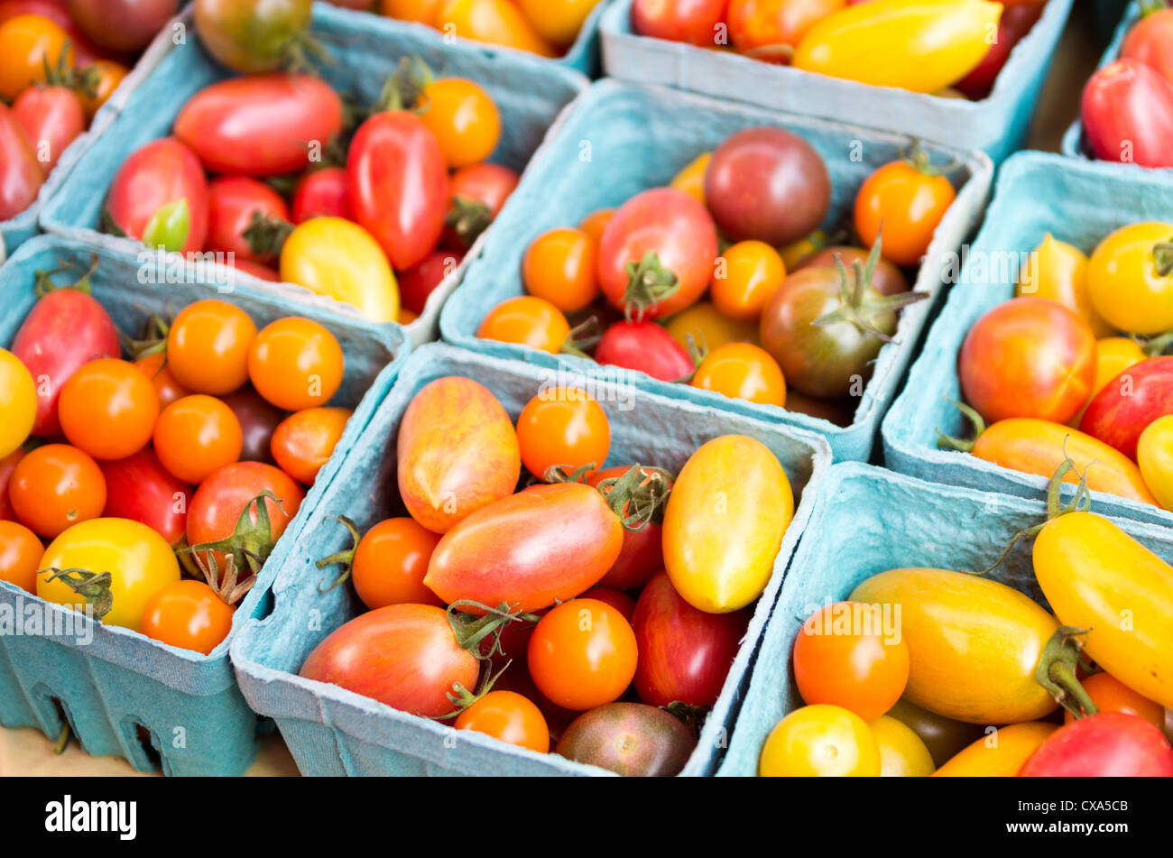 Baskets of colorful cherry tomatoes on display at the market Stock ...