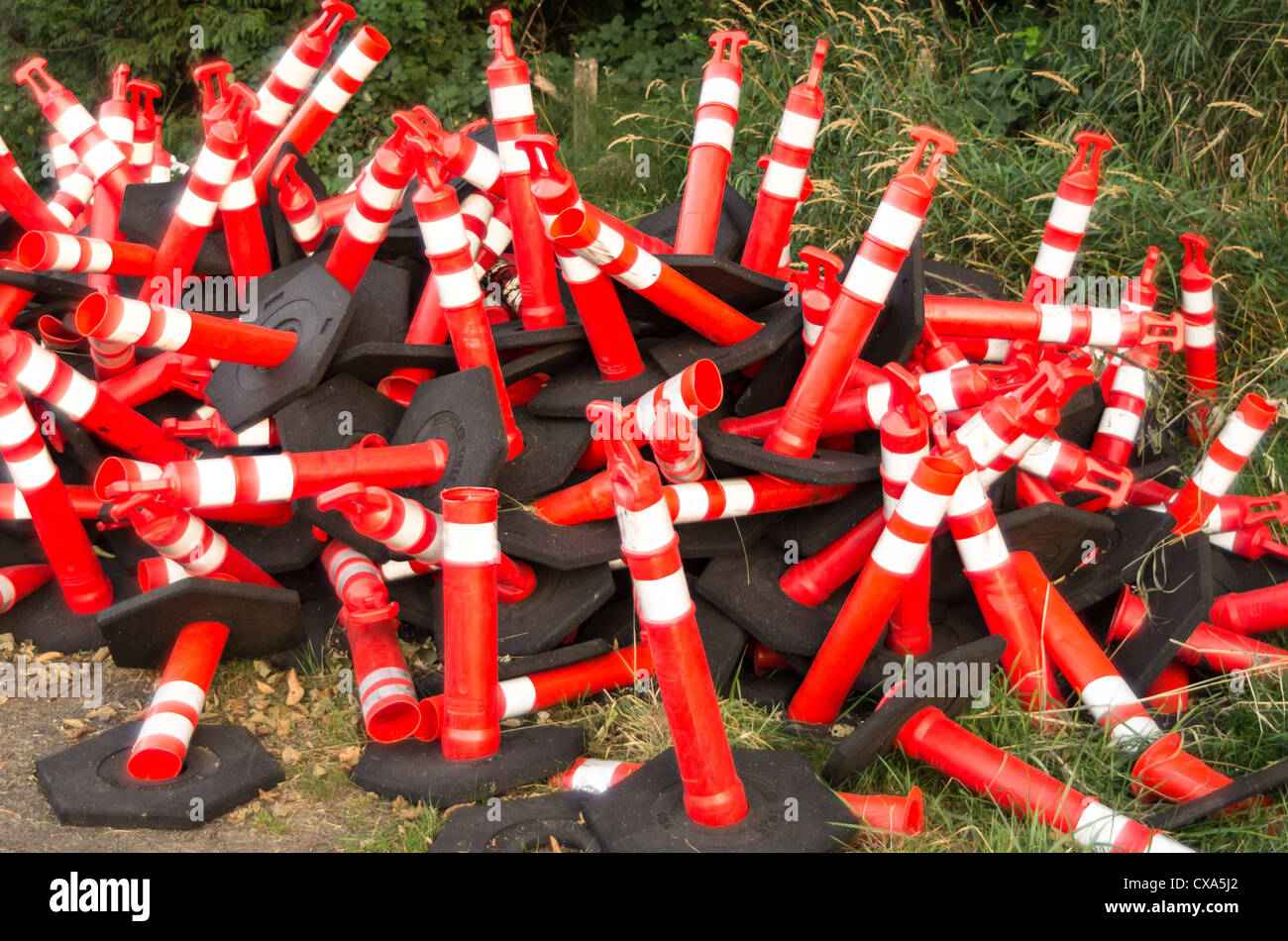 A pile of orange safety cones waiting to be used Stock Photo