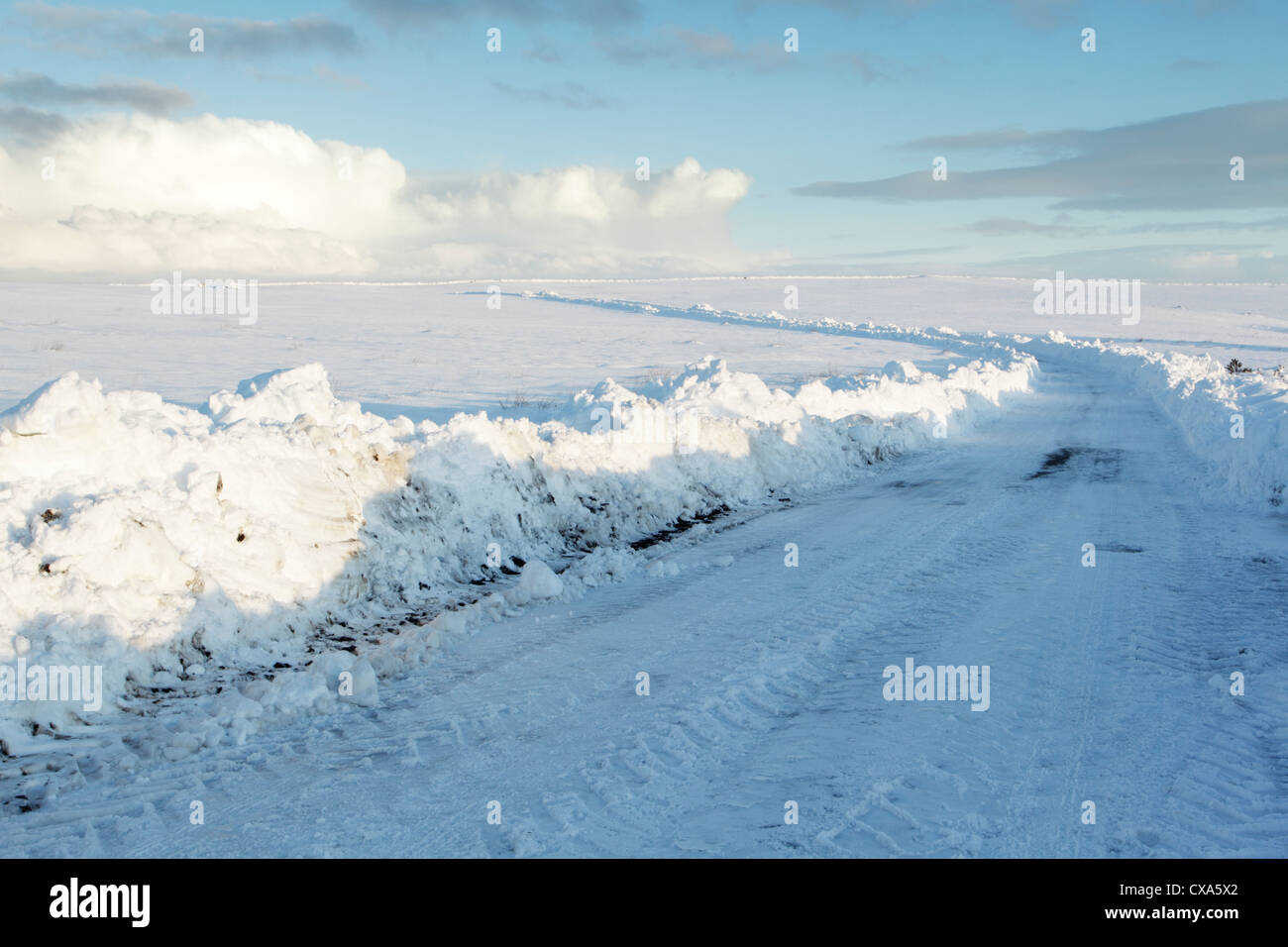 Winter view of a moorland road that has been cleared by a snowplough Stock Photo