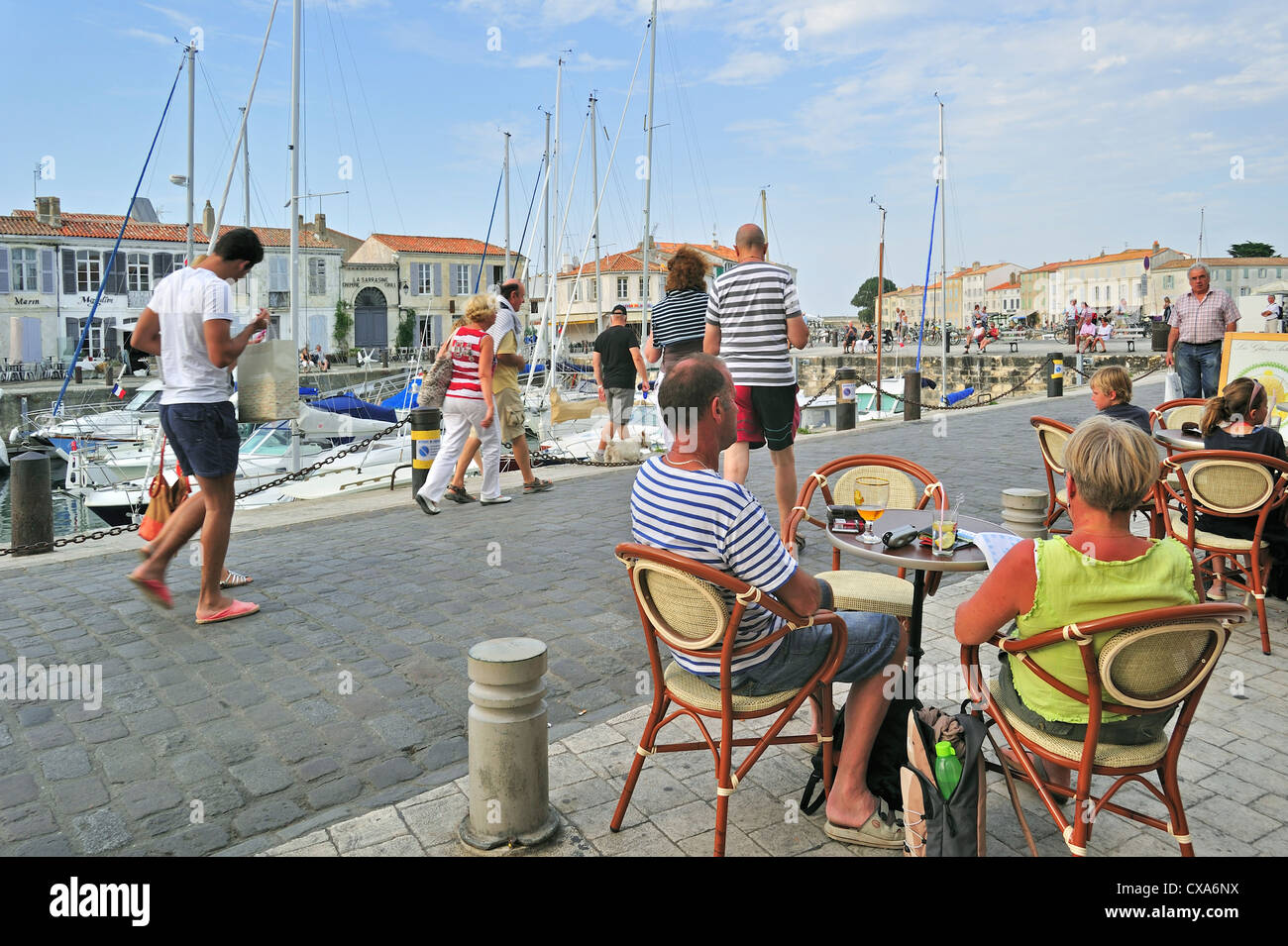 Tourists at pavement cafe in the port at Saint-Martin-de-Ré on the island Ile de Ré, Charente Maritime, France Stock Photo