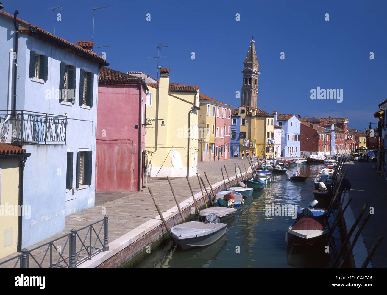 Burano San Martino Church and canal with typical colourful houses and boats Venetian lagoon Venice Veneto Italy Stock Photo