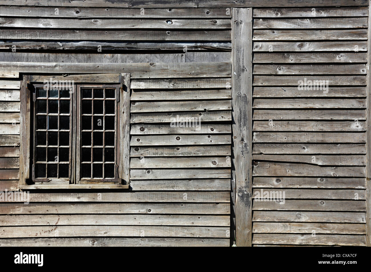 weathered clapboard siding window frame, Shelburne, Nova Scotia Stock Photo