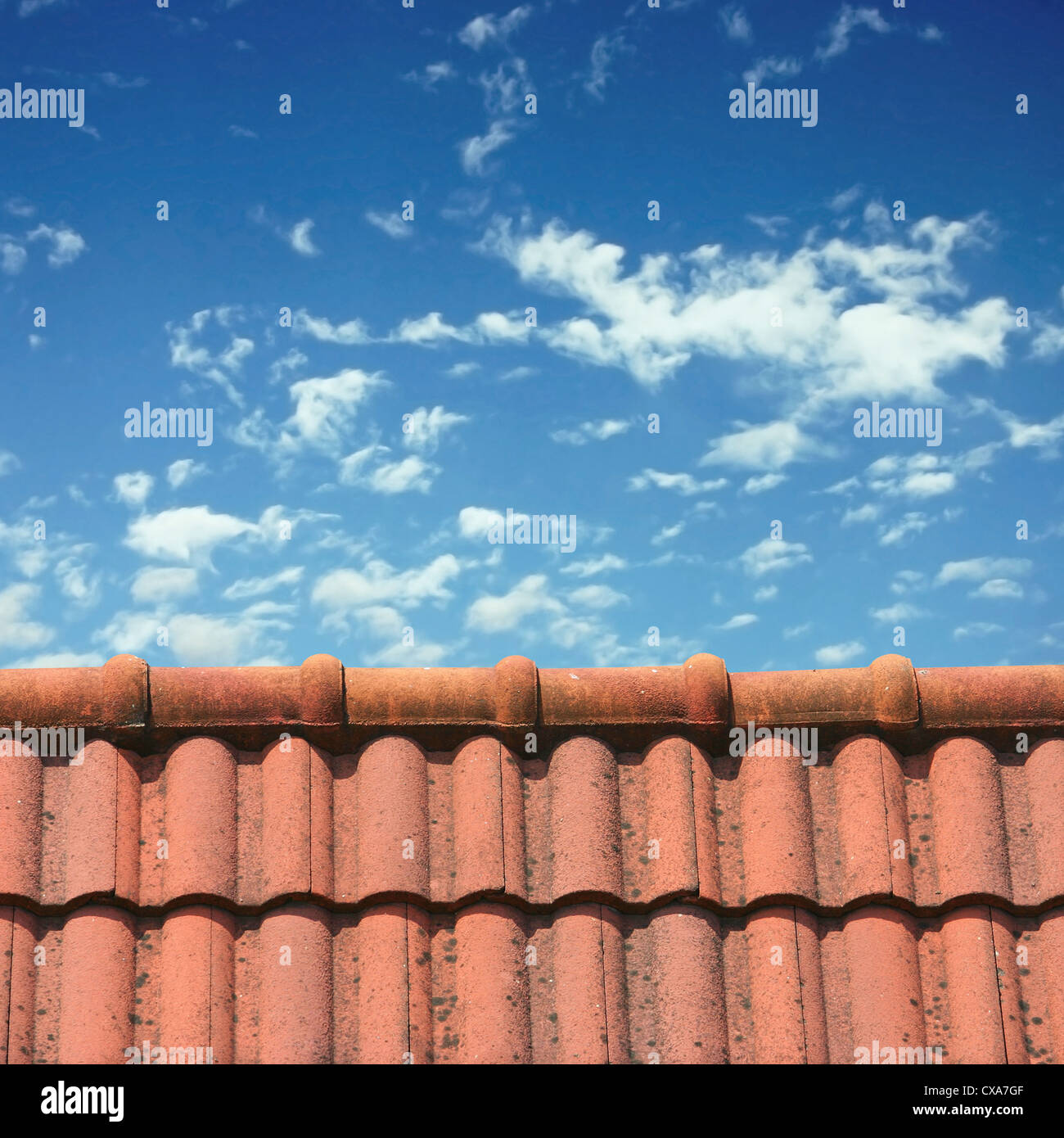 A Roof Top with Red Tiles and Blue Sky Stock Photo