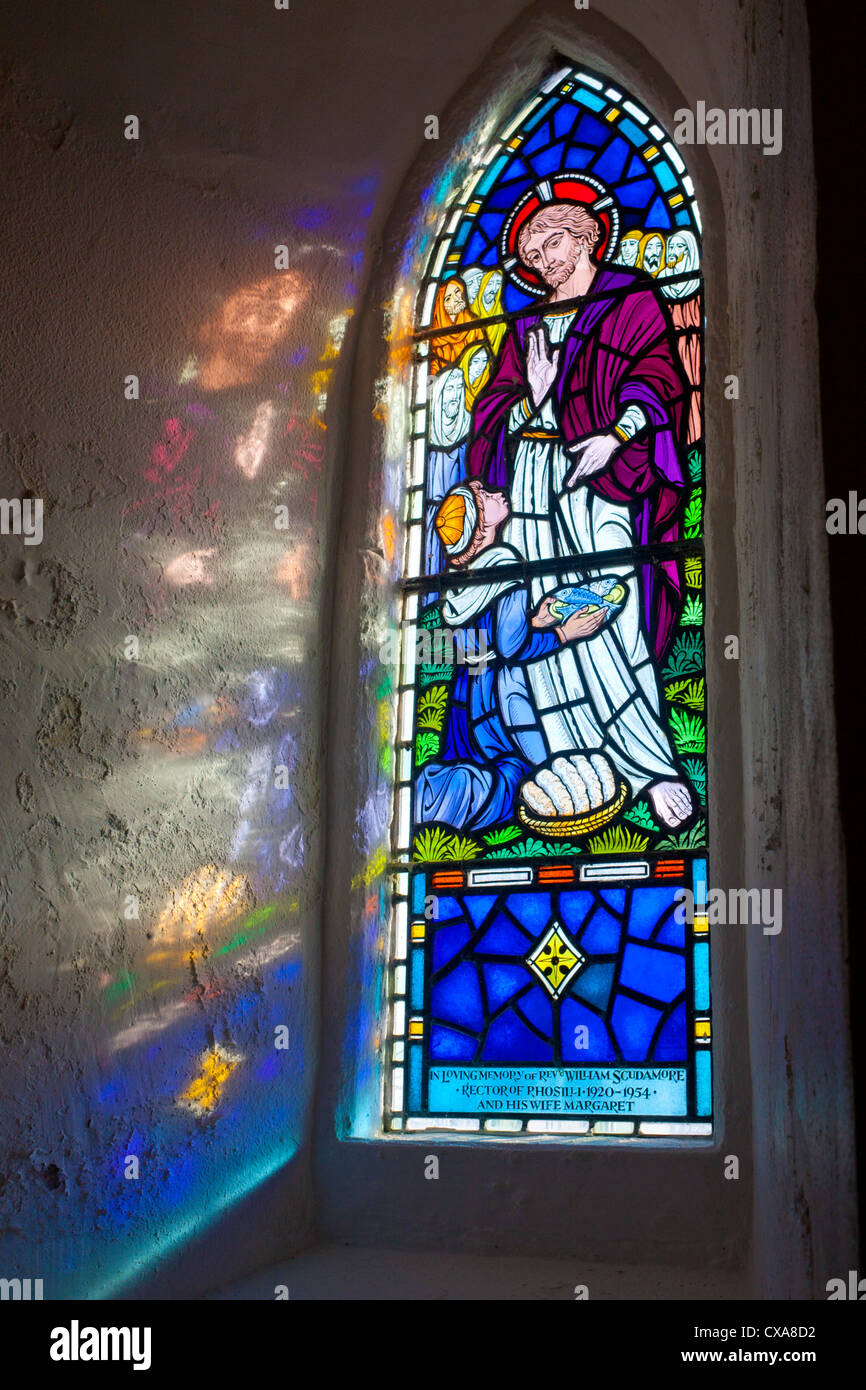 Stained glass window with sunlight reflection on wall St Mary's Church