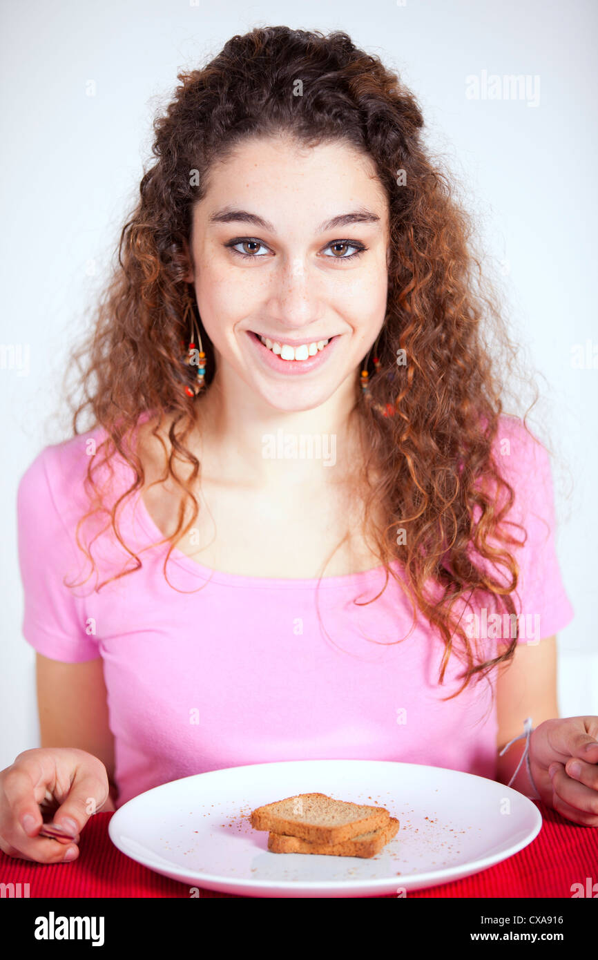 Young beautiful woman eating her morning toast Stock Photo - Alamy