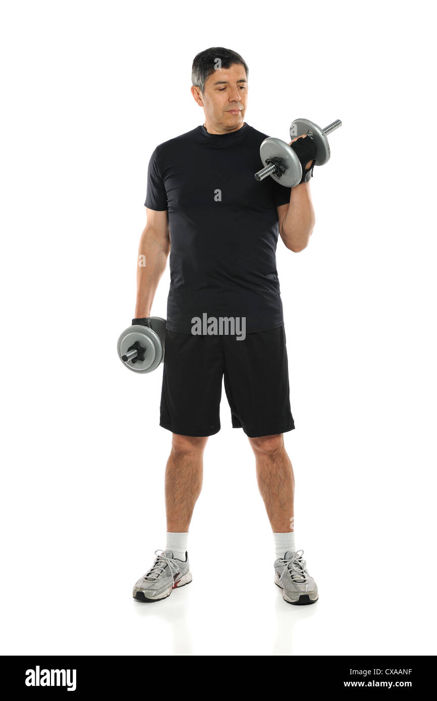 Hispanic mature man using dumbbells standing over white background Stock Photo