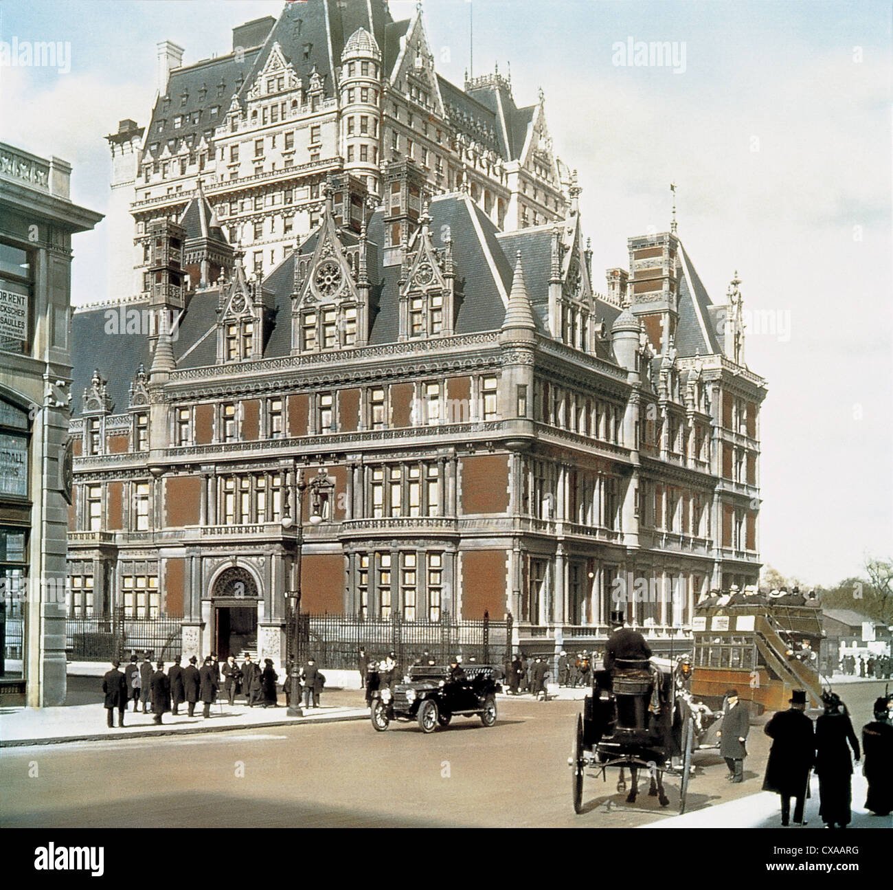 Colorized view, looking north across the intersection of 5th Avenue and 57th Street, of the Cornelius Vanderbilt II House, New York, New York, May 1910. The home, built in 1883 was the largest private home in Manhattan. Visible above it is the Plaza Hotel. (Photo by Burton Holmes) Stock Photo