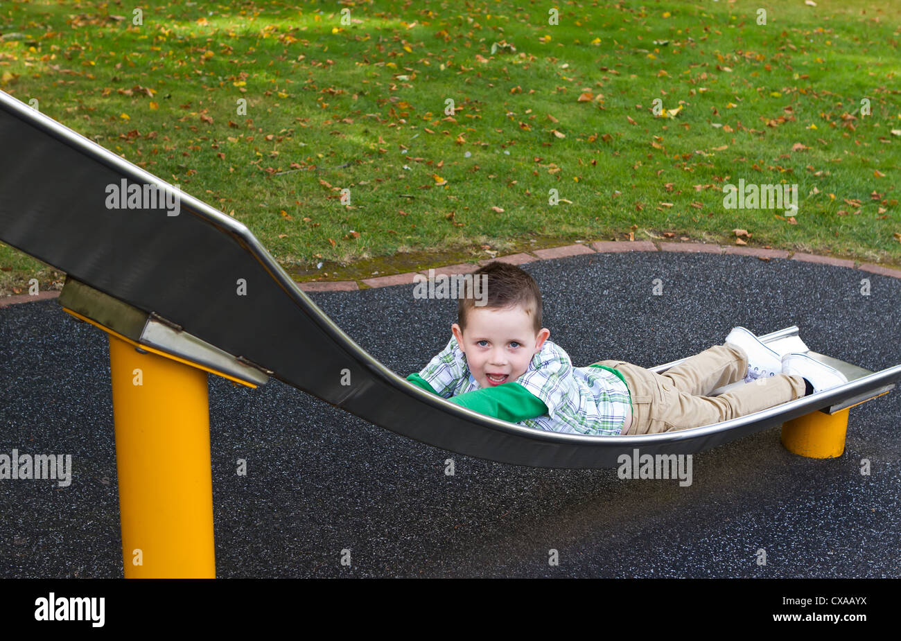 Young boy playing in the park on an overcast day Stock Photo
