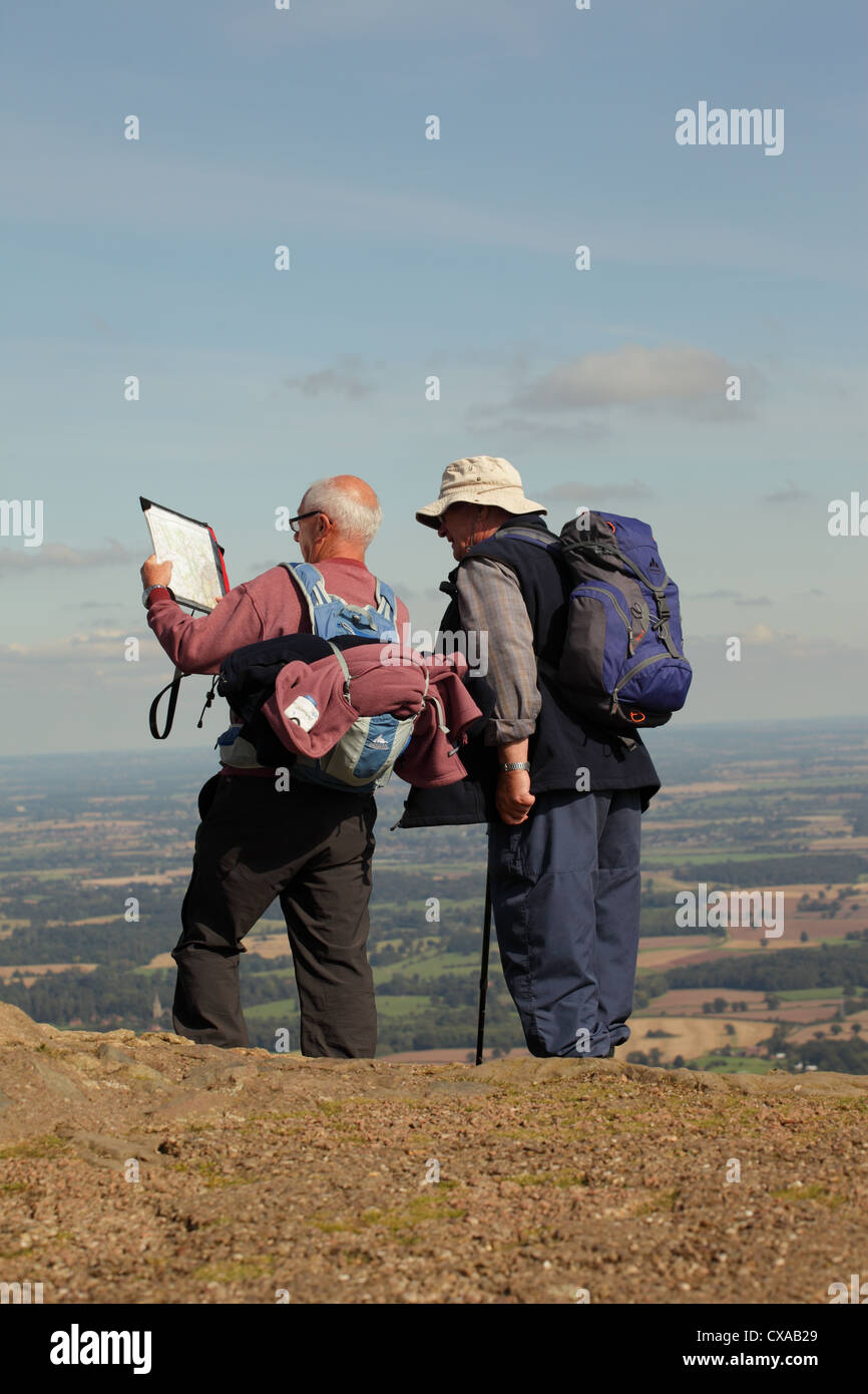 Two walkers looking at a map on the Malvern Hills UK Stock Photo Alamy