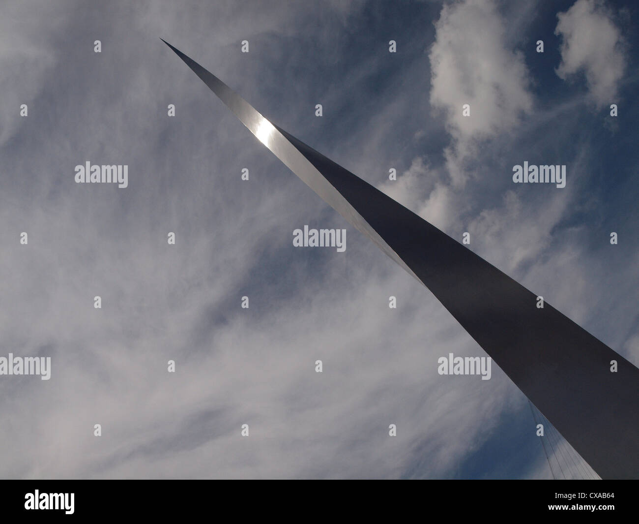 Towering spiral spire at North Greenwich twisting upwards against a blue sky with wispy clouds Stock Photo
