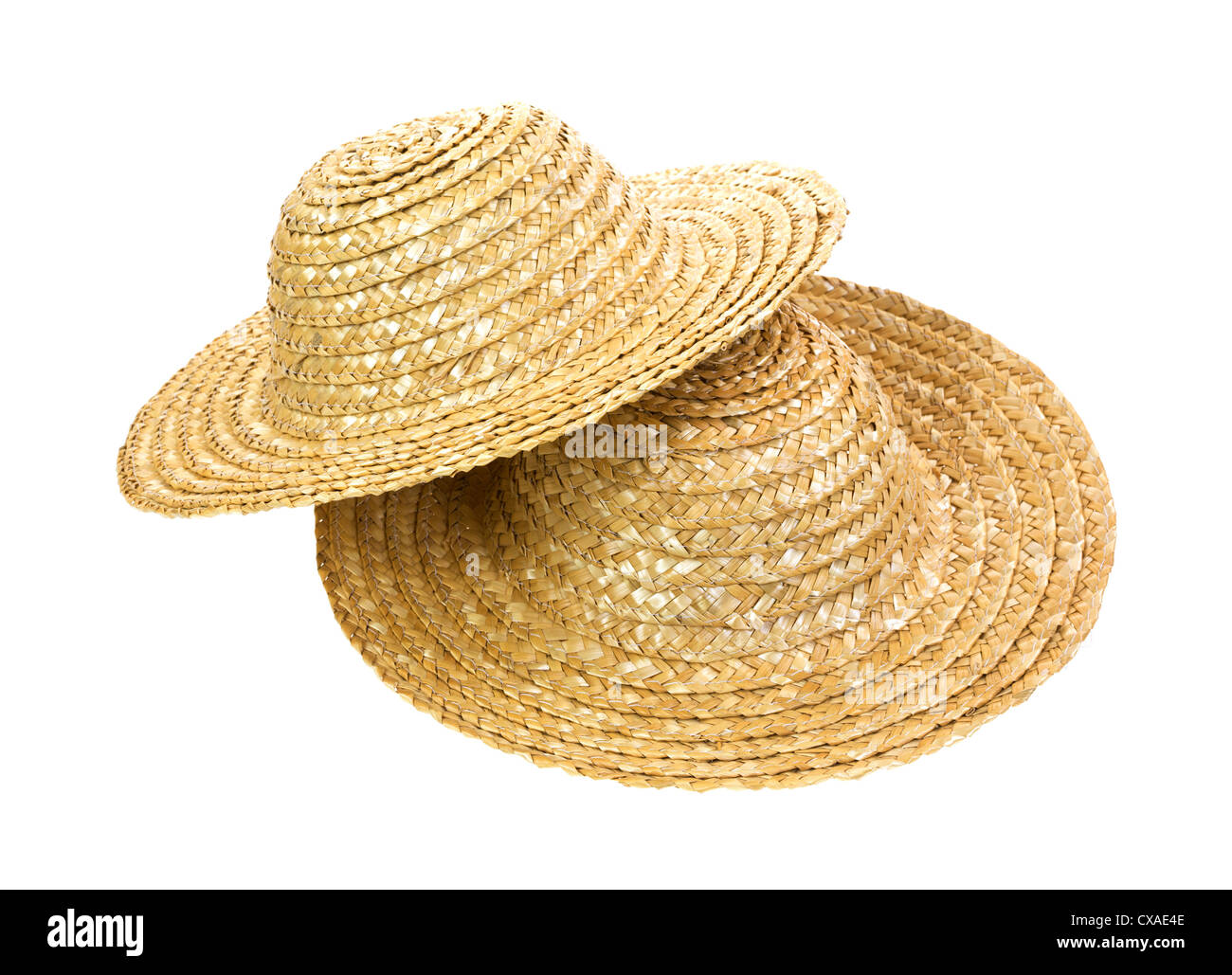 Two straw hats arranged with one atop the other on a white background. Stock Photo