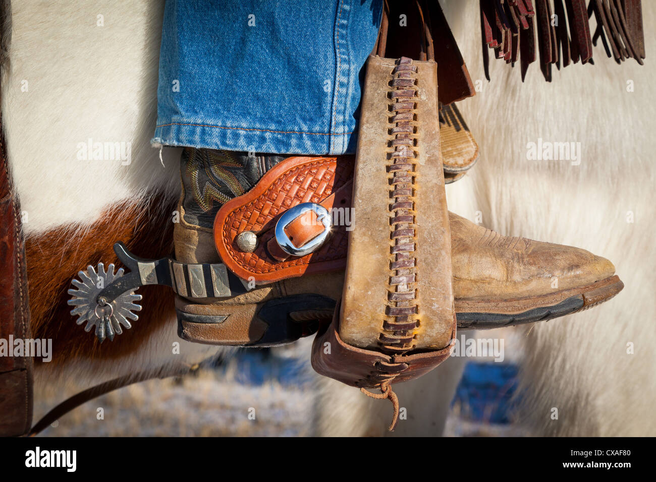 Boot with spurs in stirrup on ranch in eastern Wyoming Stock Photo