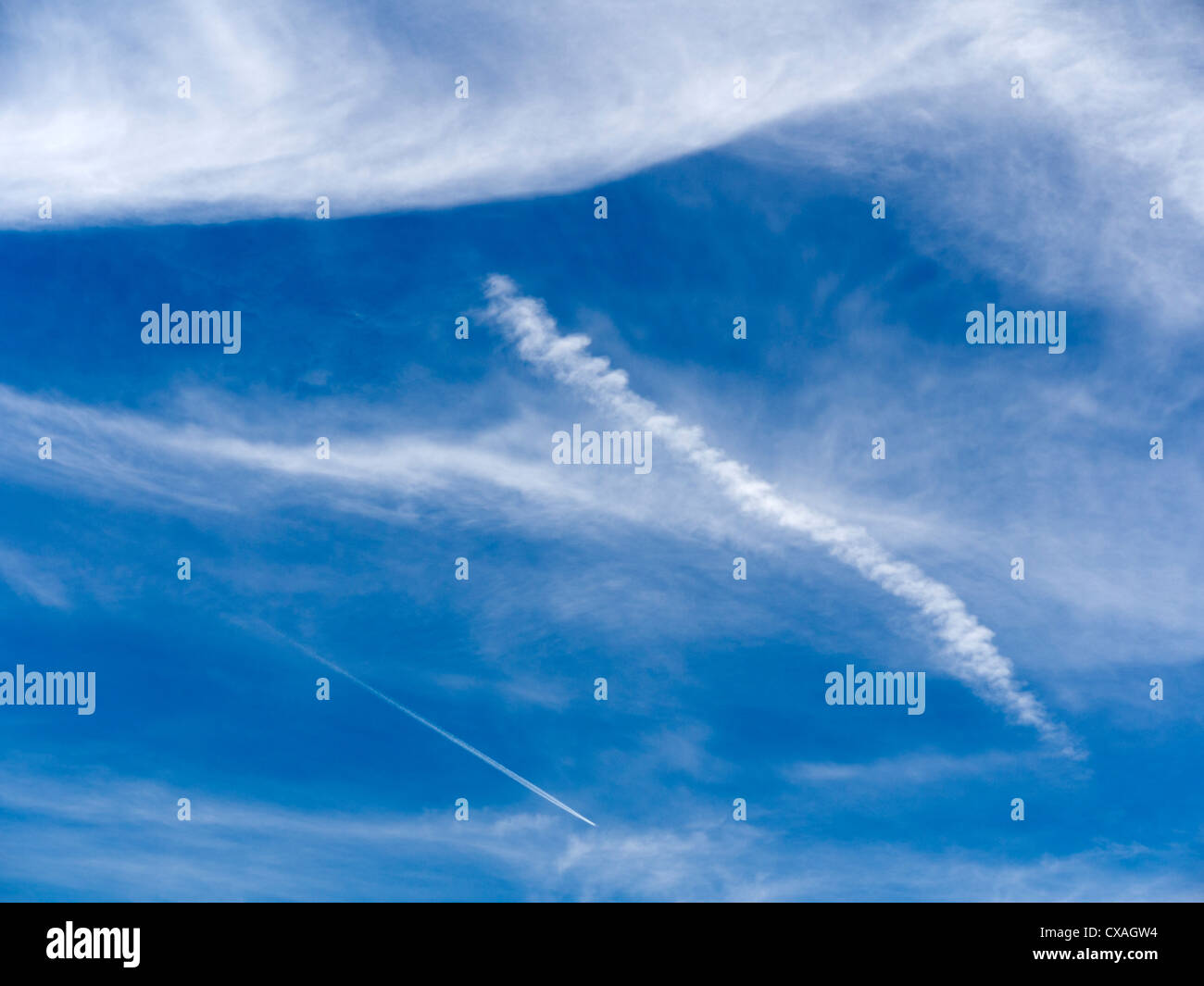 Cloudscape with contrails above Radley Village, England Stock Photo
