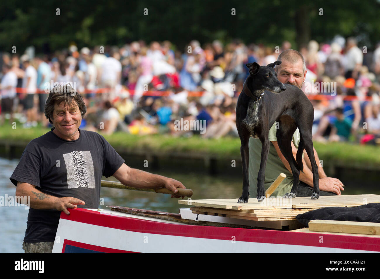 Men and dog on houseboat cruising the Thames at Abingdon, Dragon Boat Festival 2012 Stock Photo