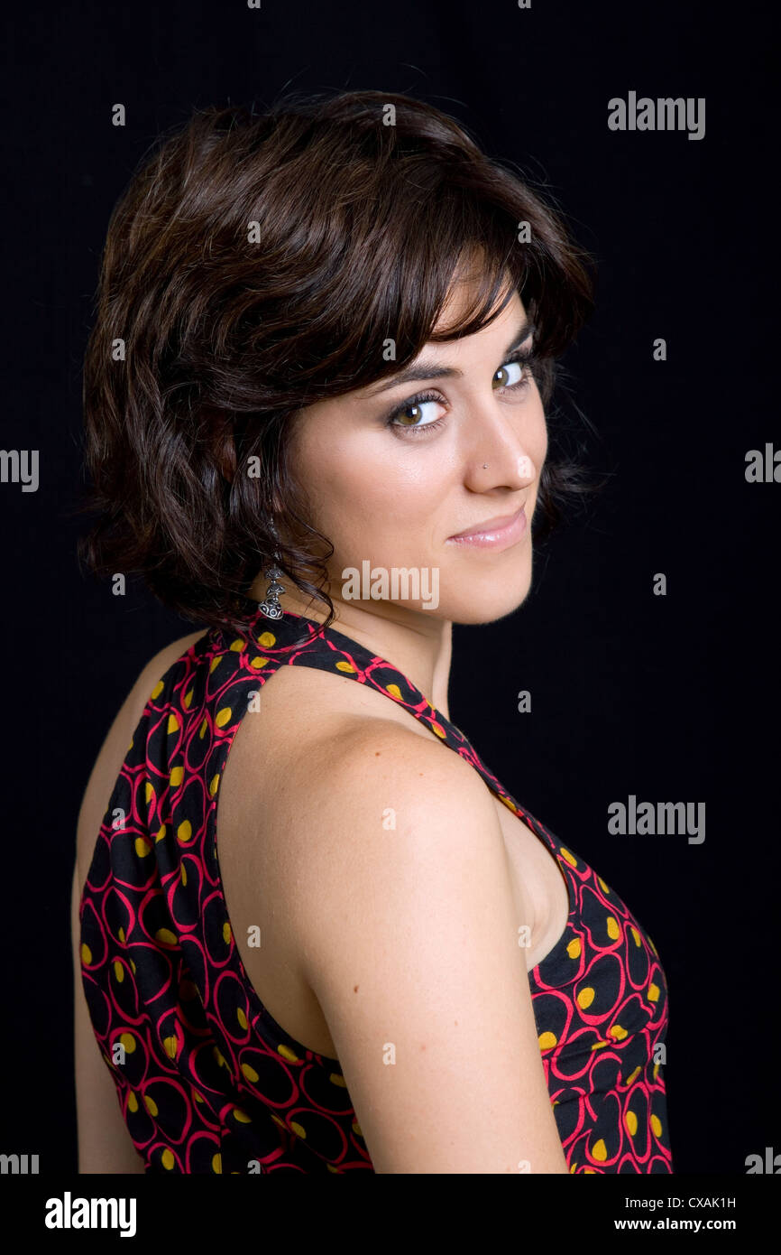 young beautiful brunette portrait against black background Stock Photo ...