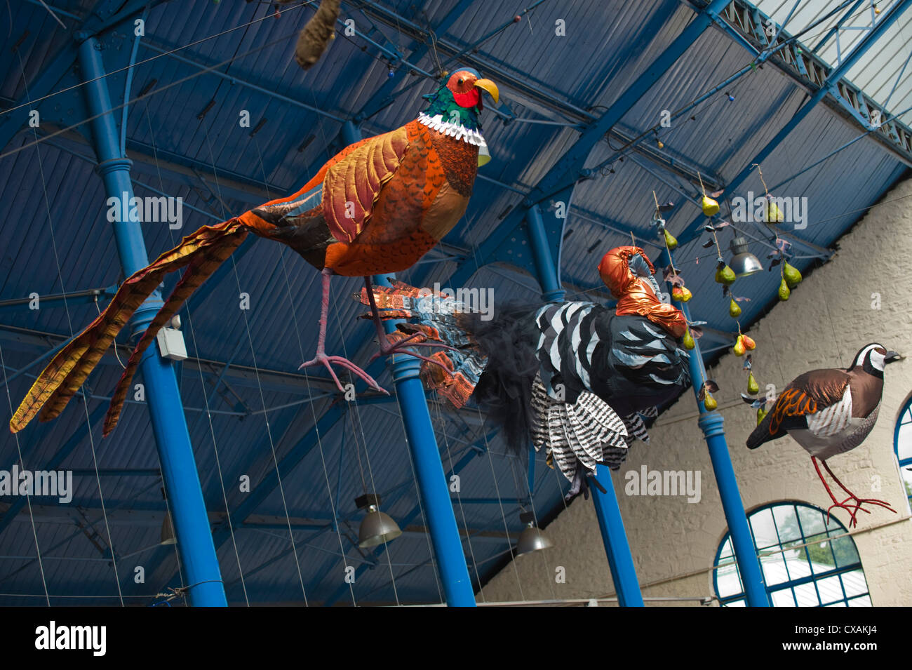 Art installation of game birds hanging from the roof of the market hall during Abergavenny Food Festival Stock Photo