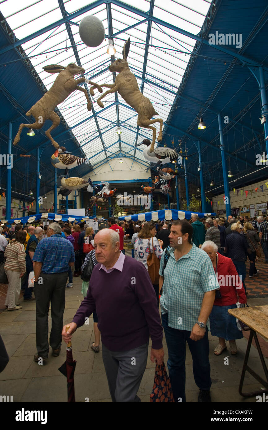 Art installation of game birds and leaping hares hanging from the roof of the market hall during Abergavenny Food Festival Stock Photo