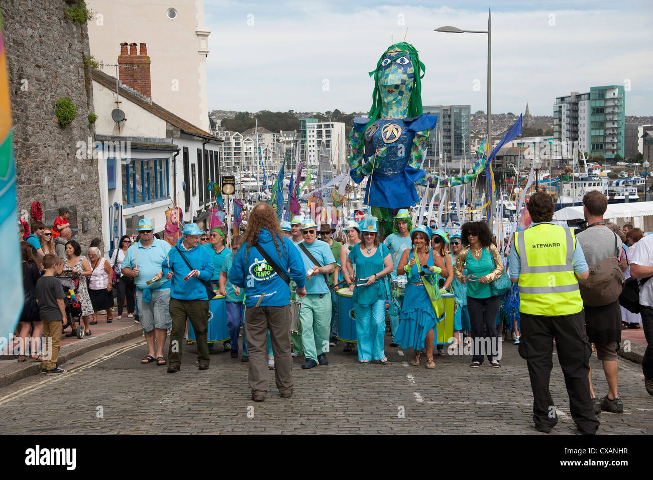 Crooked Tempo Samba Band leading a parade from the Plymouth Barbican Plymouth Devon England UK Stock Photo