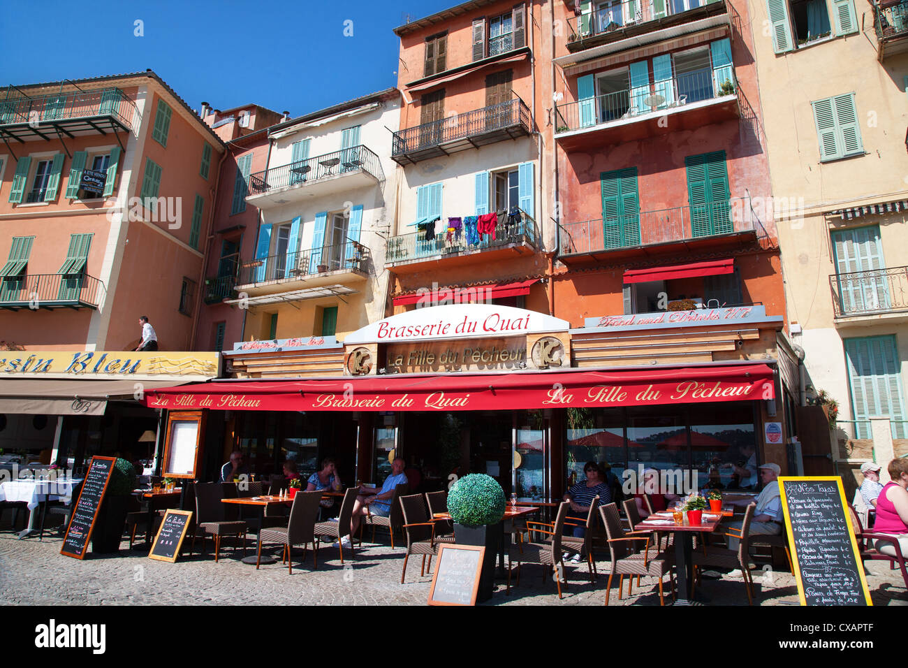 Facade of restaurants along waterfront, Villefranche, Alpes-Maritimes, Provence-Alpes-Cote d'Azur, French Riviera, France Stock Photo