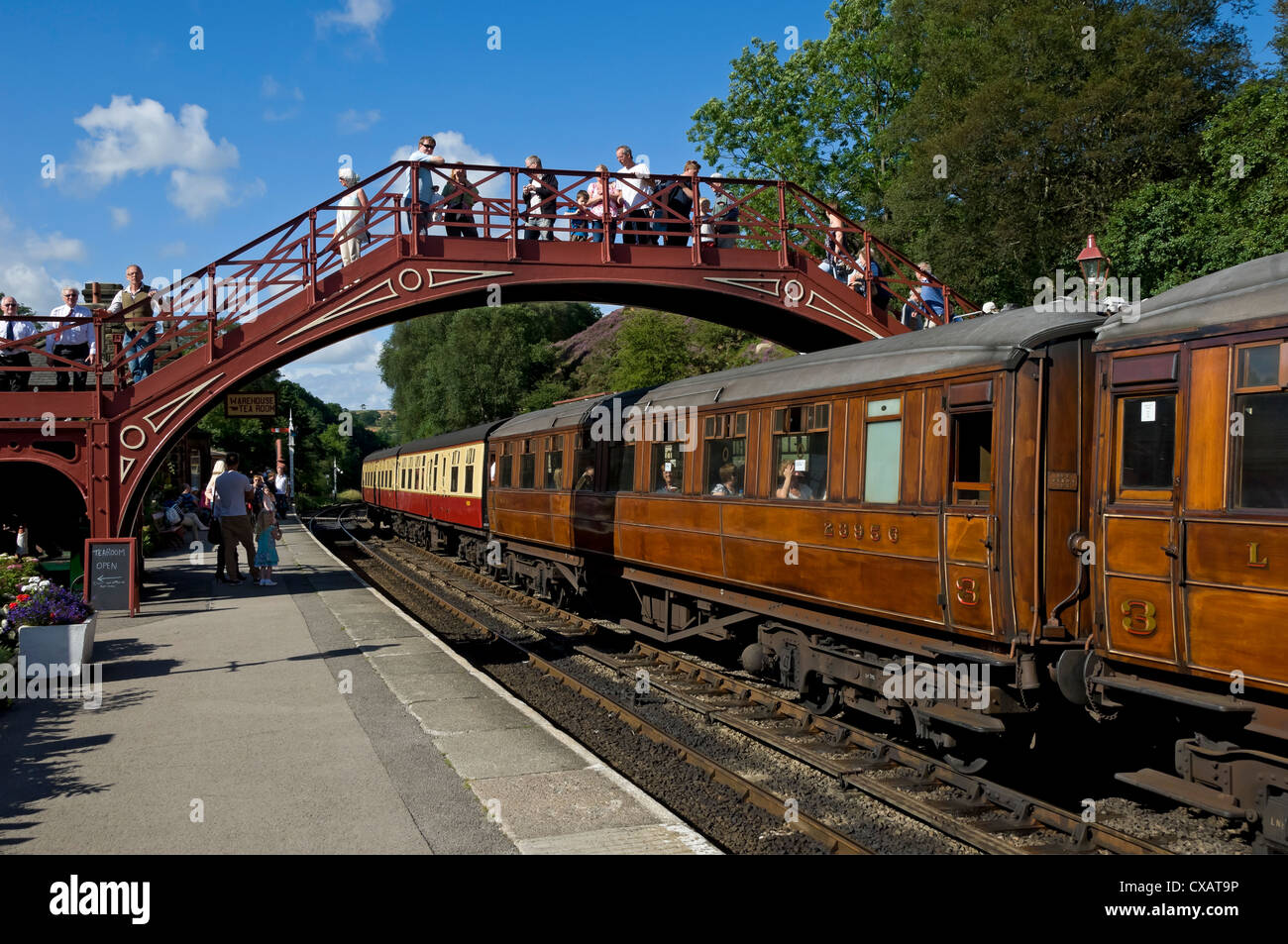 Tourists people watching train at Goathland Railway Station platform in summer NYMR North Yorkshire England UK United Kingdom GB Great Britain Stock Photo